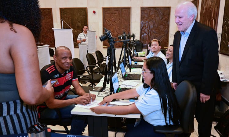 jovem com deficiência visual participa, ao lado de equipe do Detran.RJ, de ação social para público PCD